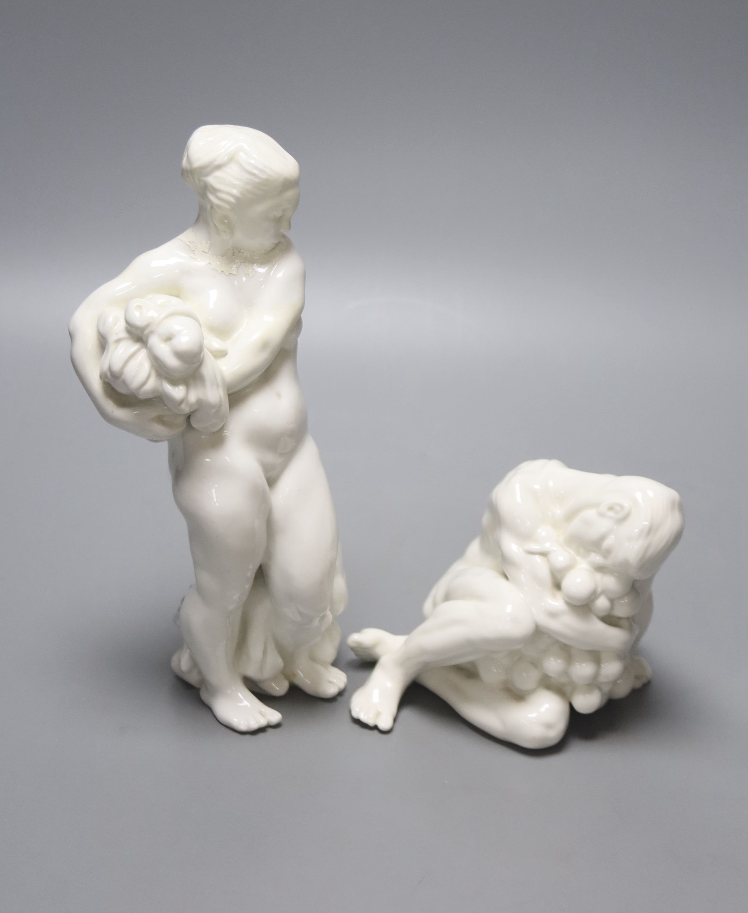 Kai Neilsen (1882-1924) for Bing & Grondahl, Woman with harvest and child, model 4031, 22 cm and seated man holding grapes, model 4024, height 24cm